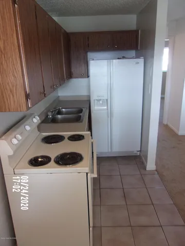 a kitchen with a stove and a refrigerator