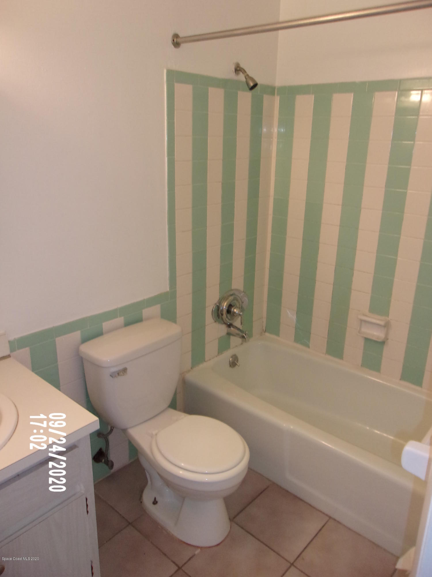 1713 Dixon Boulevard, Unit 156 Cocoa, FL 32922 - Photo 7 of 12 a bathroom with a toilet and a bathtub