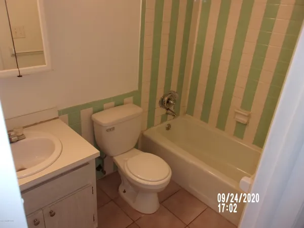 a white toilet sitting next to a bathroom sink