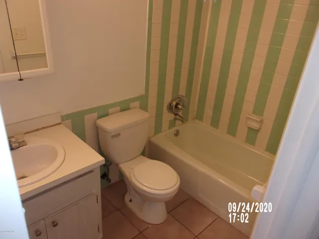 a white toilet sitting next to a bathroom sink