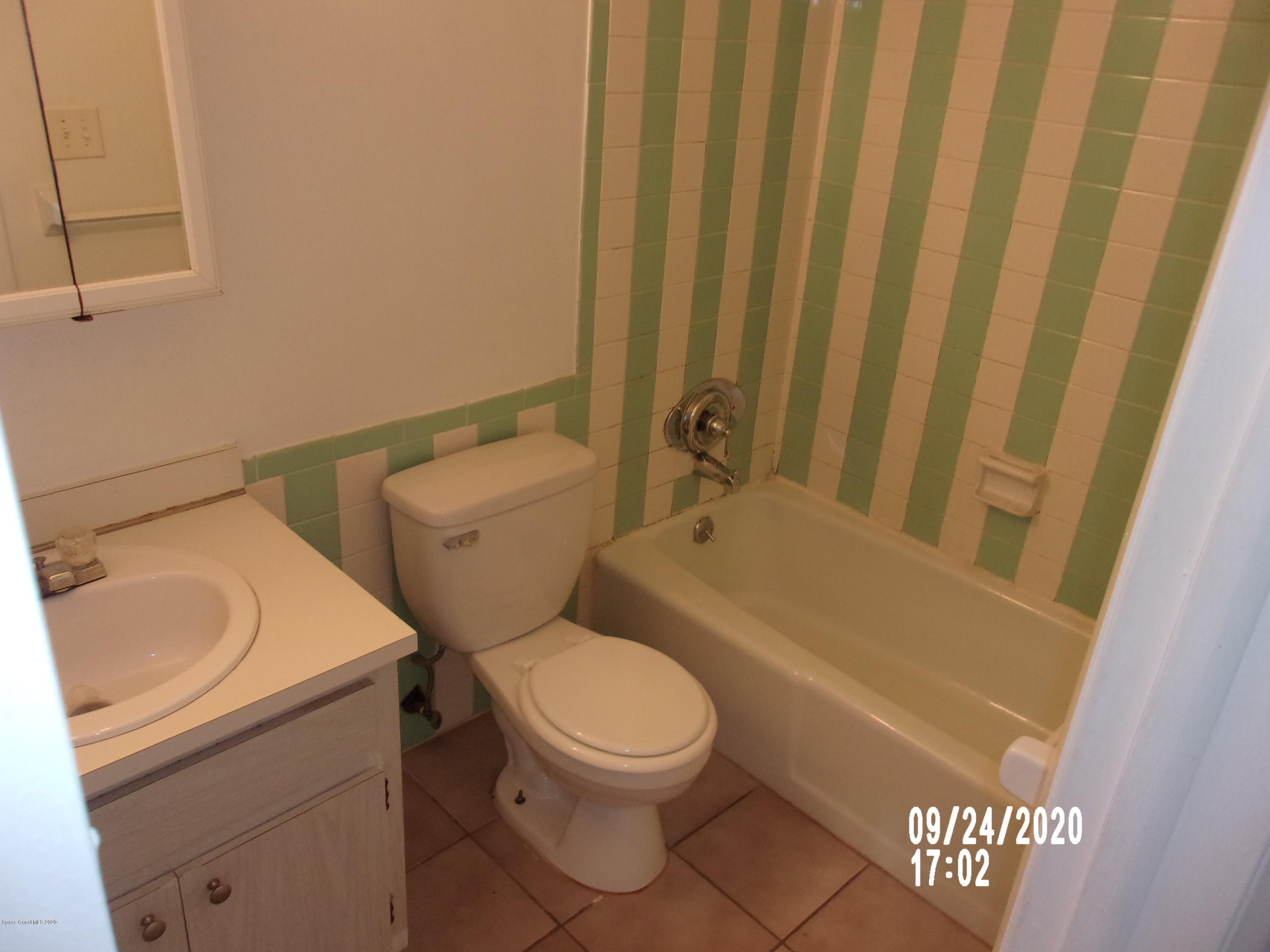 1713 Dixon Boulevard, Unit 156 Cocoa, FL 32922 - Photo 8 of 12 a white toilet sitting next to a bathroom sink
