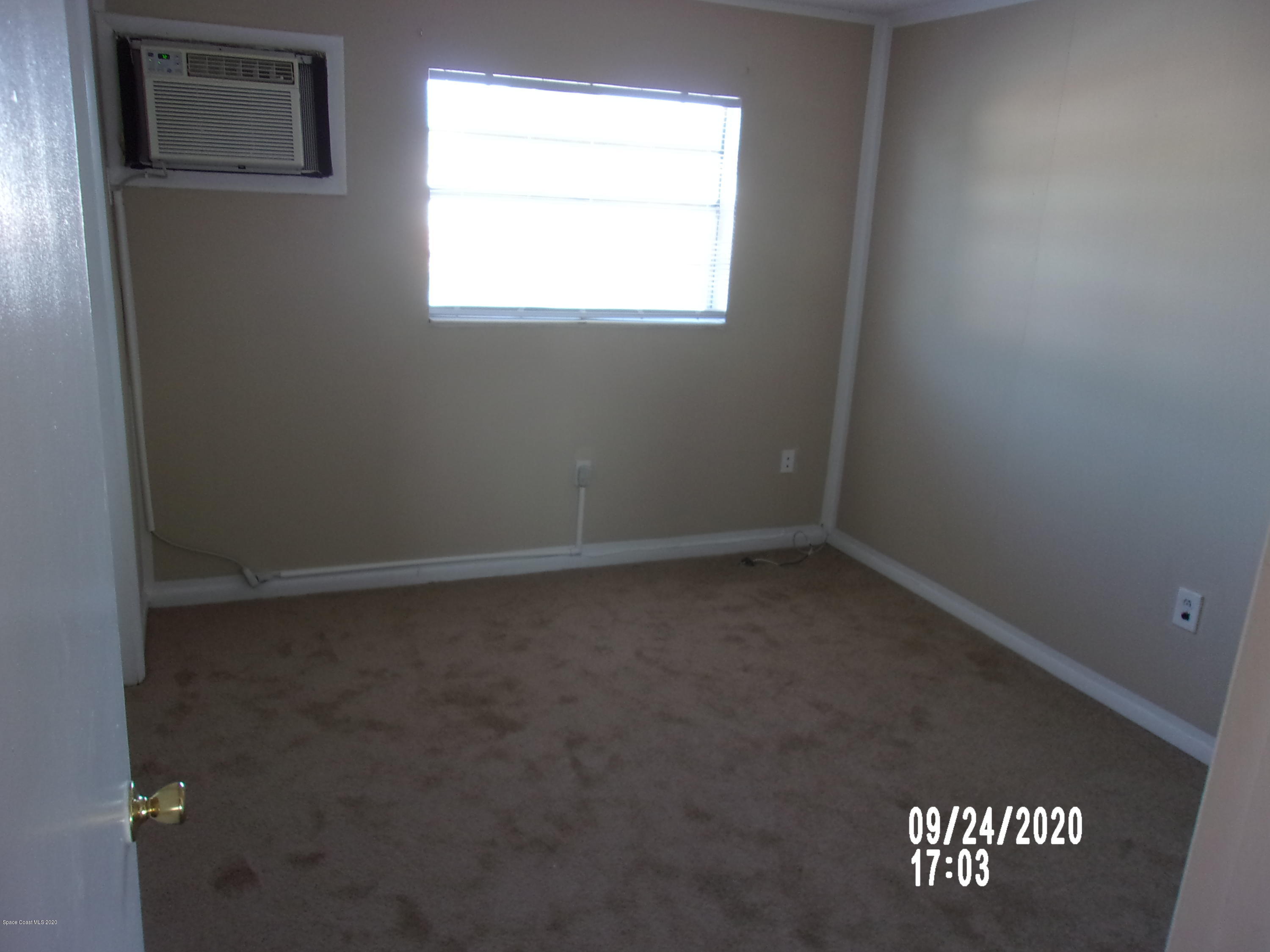 1713 Dixon Boulevard, Unit 156 Cocoa, FL 32922 - Photo 10 of 12 an empty room with a window