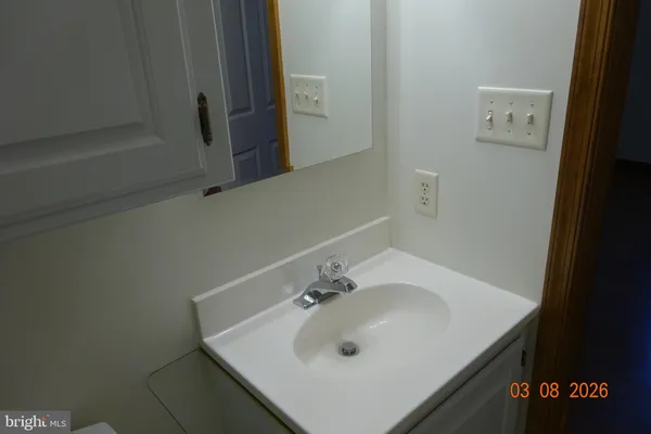 a picture of a bathroom with a shower and a door