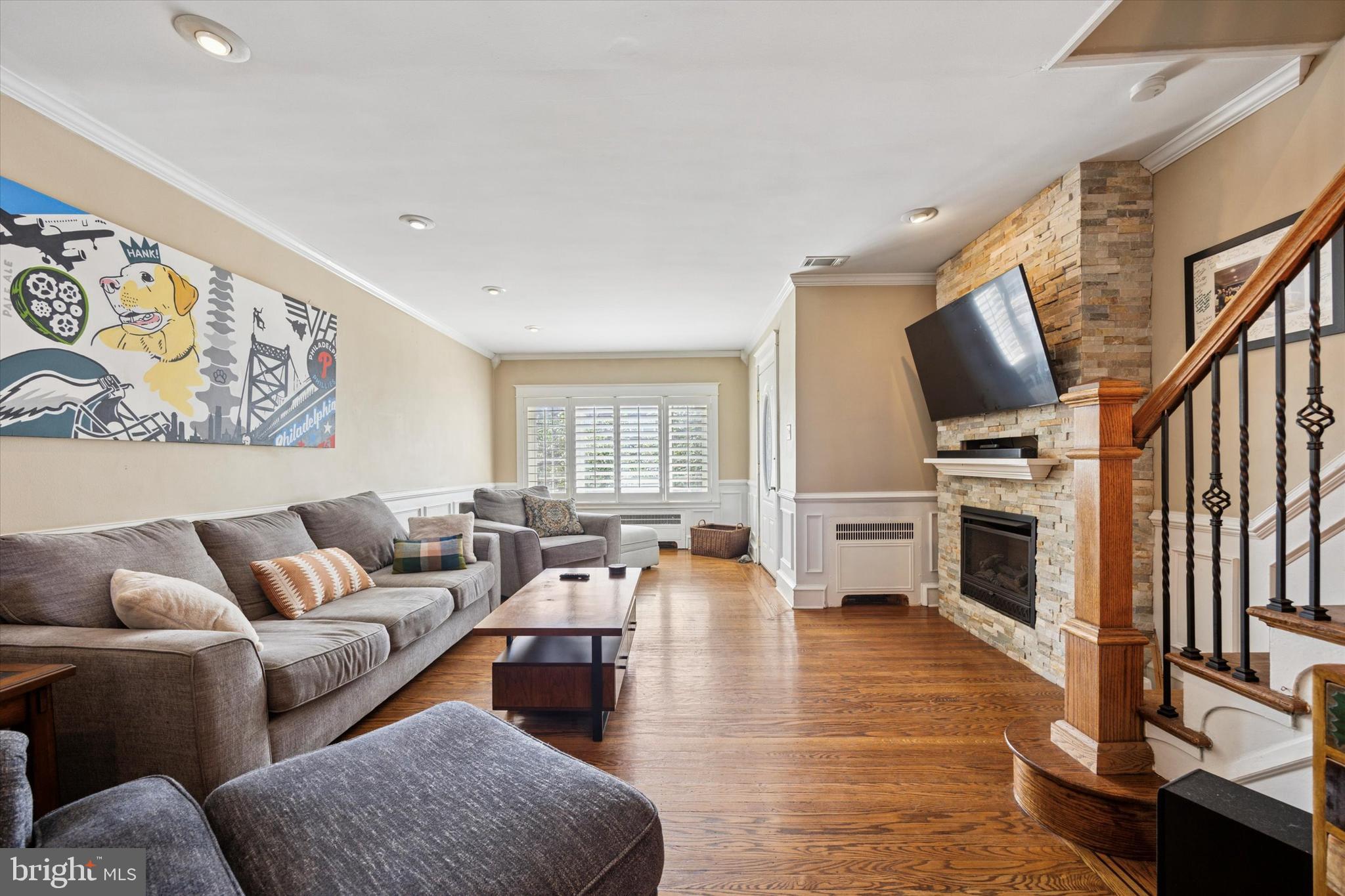2935 South 13th Street Philadelphia, PA 19148 - Photo 1 of 24 a living room with furniture flat screen tv and a fireplace