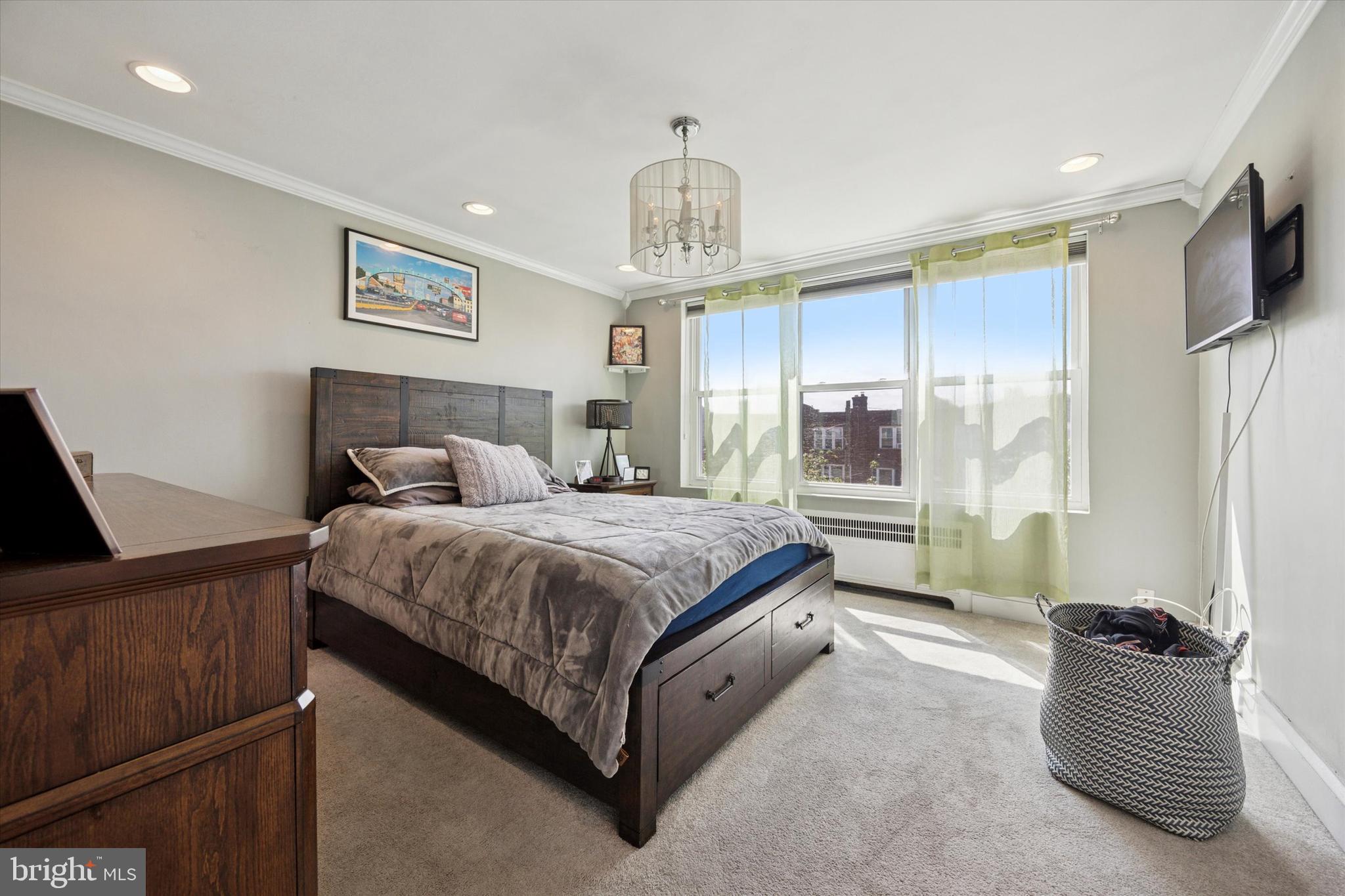 2935 South 13th Street Philadelphia, PA 19148 - Photo 11 of 24 a spacious bedroom with a bed and a couch