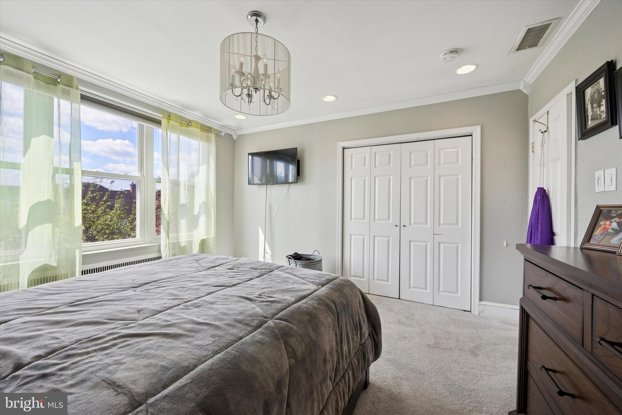 2935 South 13th Street Philadelphia, PA 19148 - Photo 13 of 24 a bedroom with a bed and a chandelier
