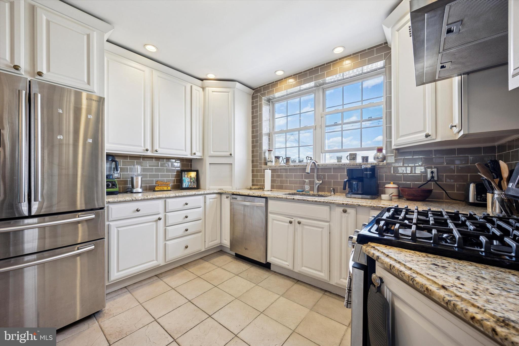 2935 South 13th Street Philadelphia, PA 19148 - Photo 4 of 24 a kitchen with stainless steel appliances granite countertop a stove a sink dishwasher and a refrigerator