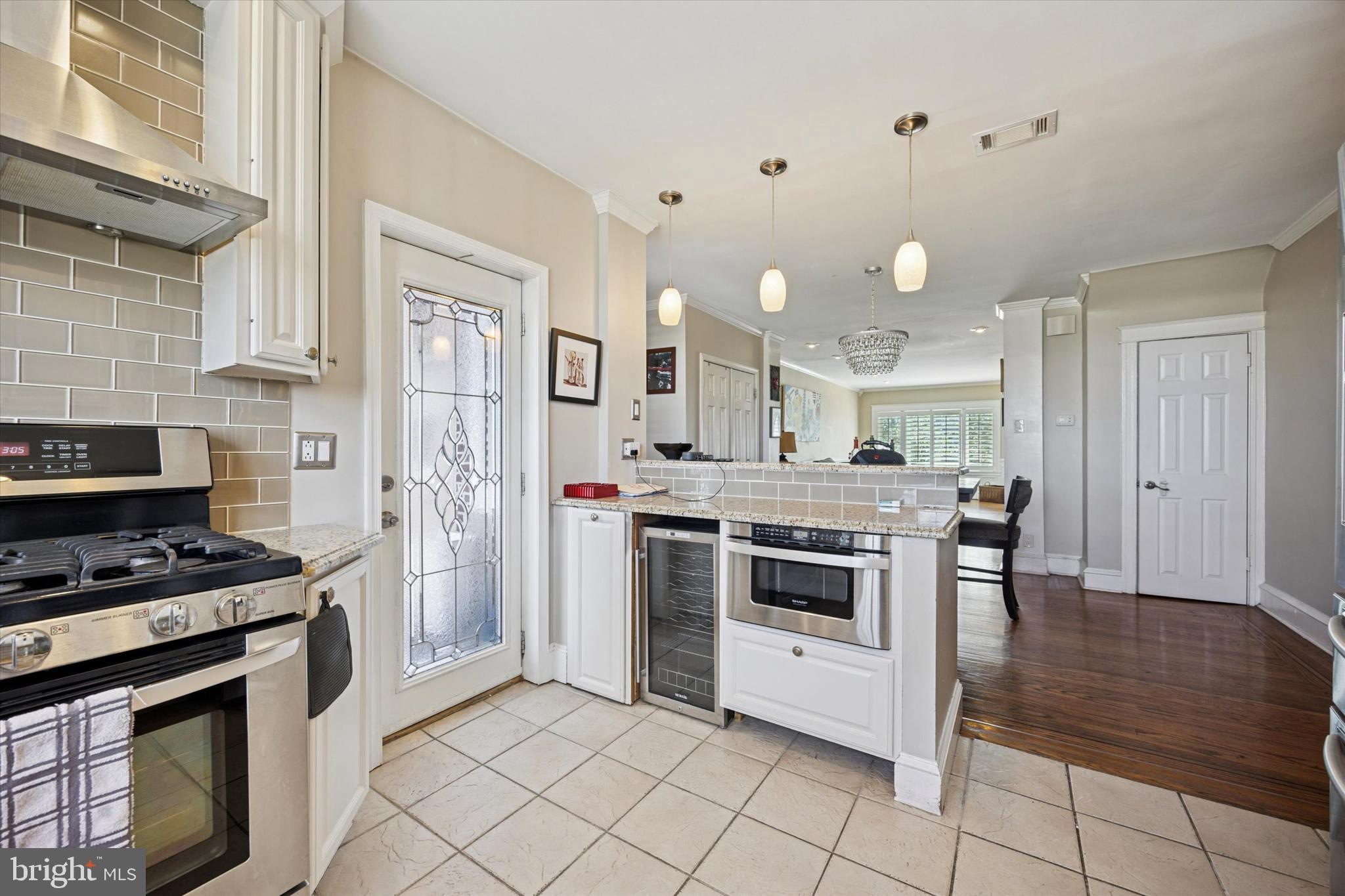 2935 South 13th Street Philadelphia, PA 19148 - Photo 6 of 24 a kitchen with stainless steel appliances a stove a sink and a refrigerator