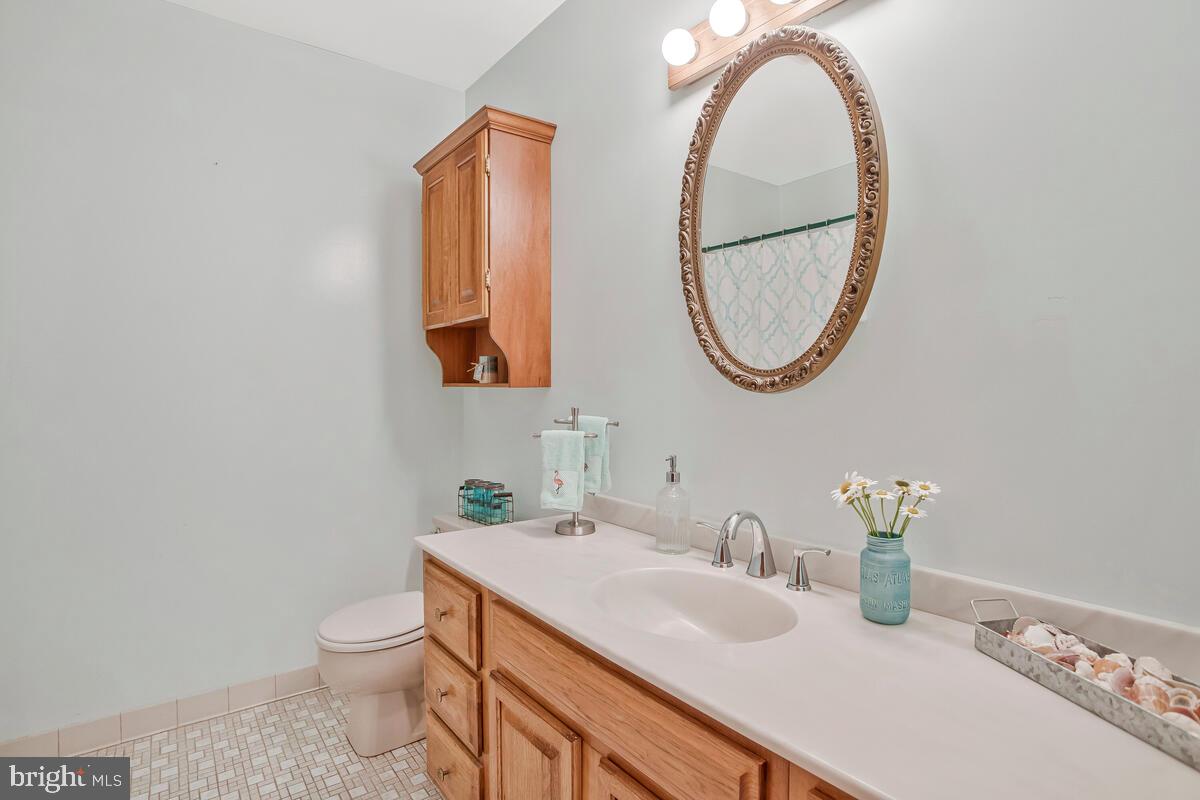 626 Fairmount Road Linthicum Heights, MD 21090 - Photo 39 of 58 a bathroom with a granite countertop sink and a mirror