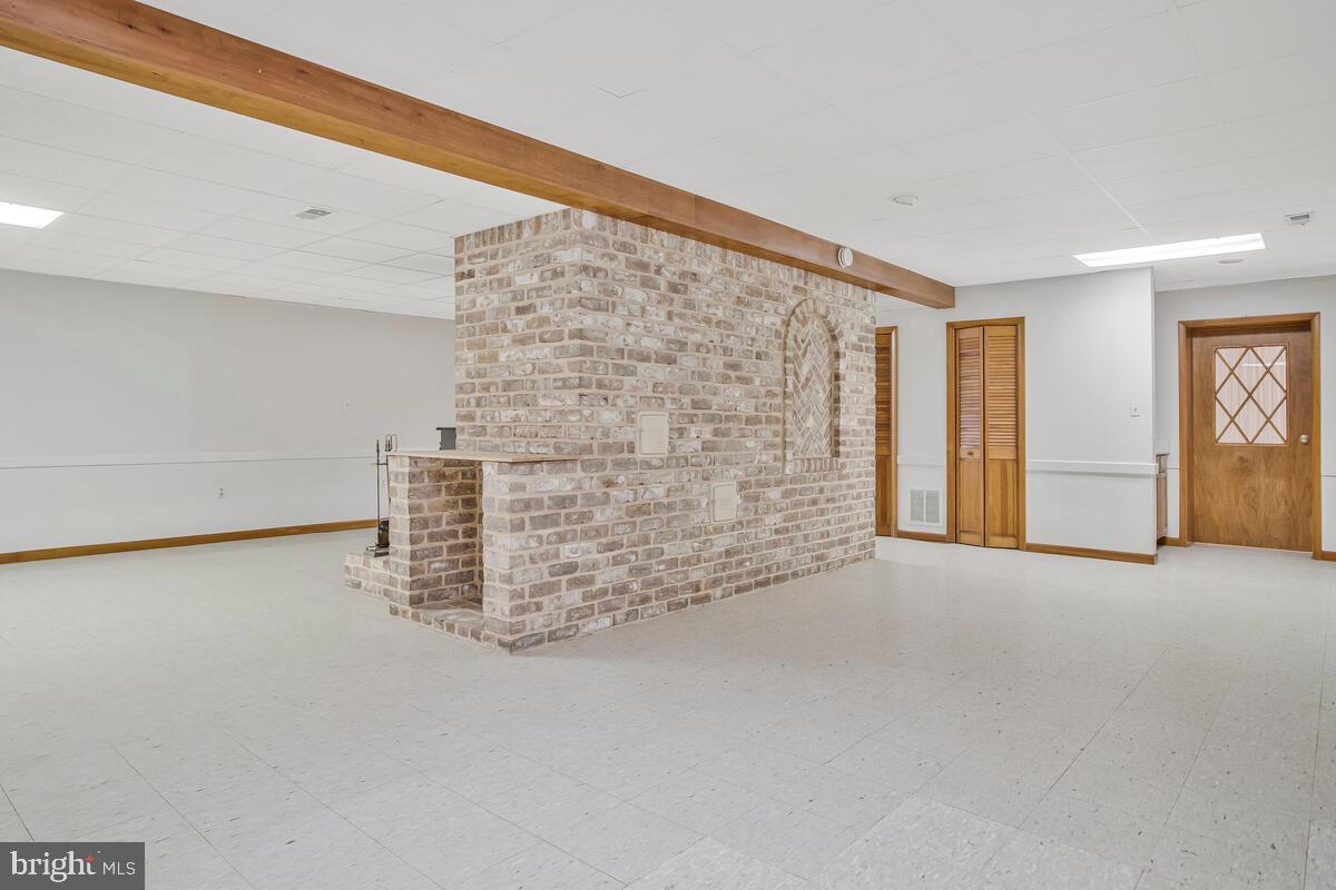 626 Fairmount Road Linthicum Heights, MD 21090 - Photo 45 of 58 a view of an empty room with brick wall and windows