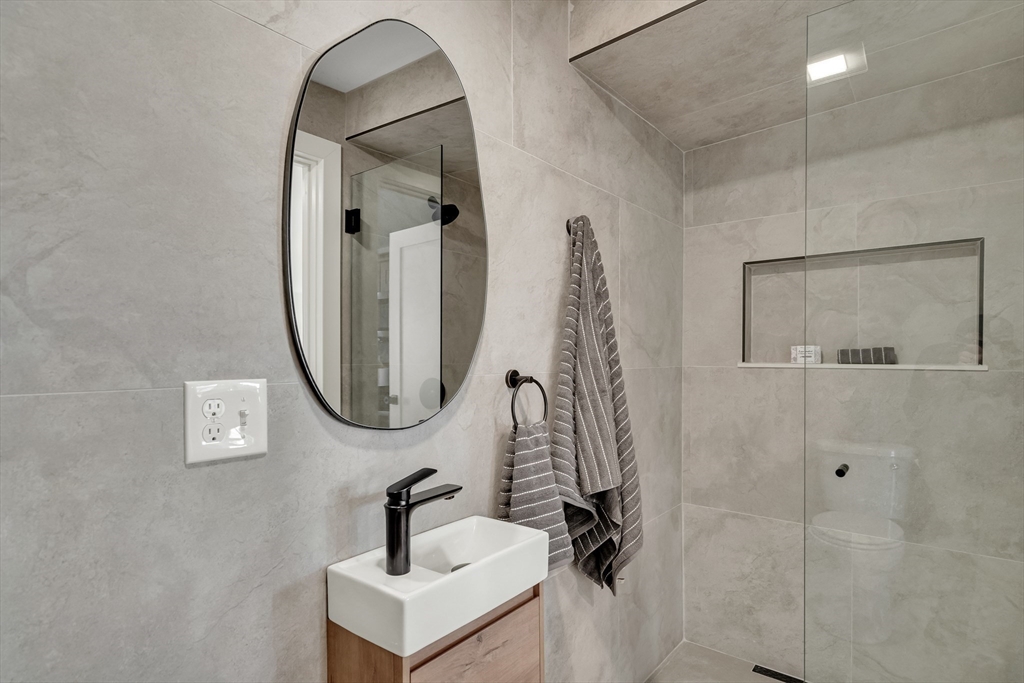 56 Riverview Street Dedham, MA 02026 - Photo 18 of 29 a bathroom with a sink and mirror