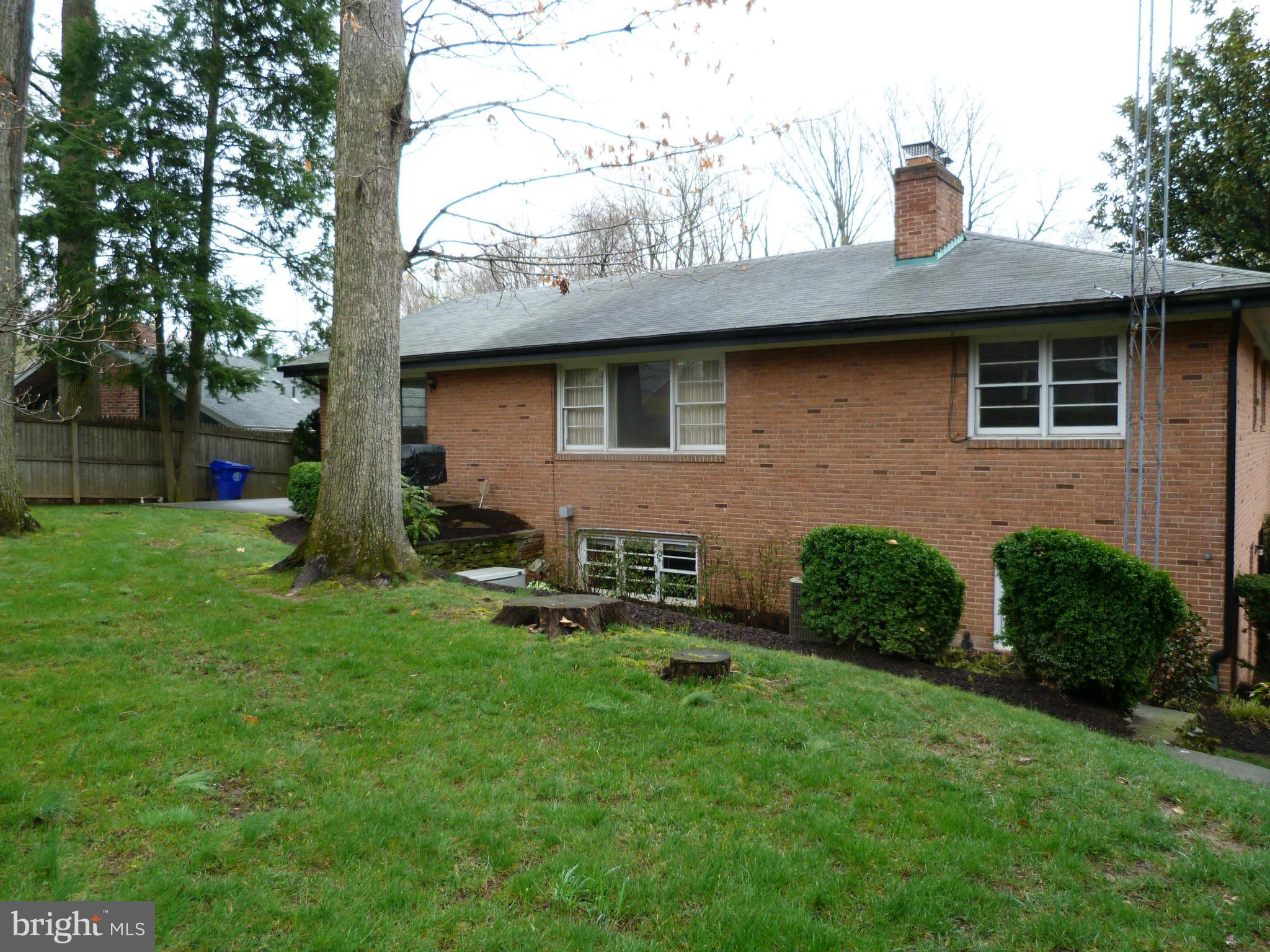 9508 Midwood Road Silver Spring, MD 20910 - Photo 2 of 10 a front view of a house with a yard and seating space