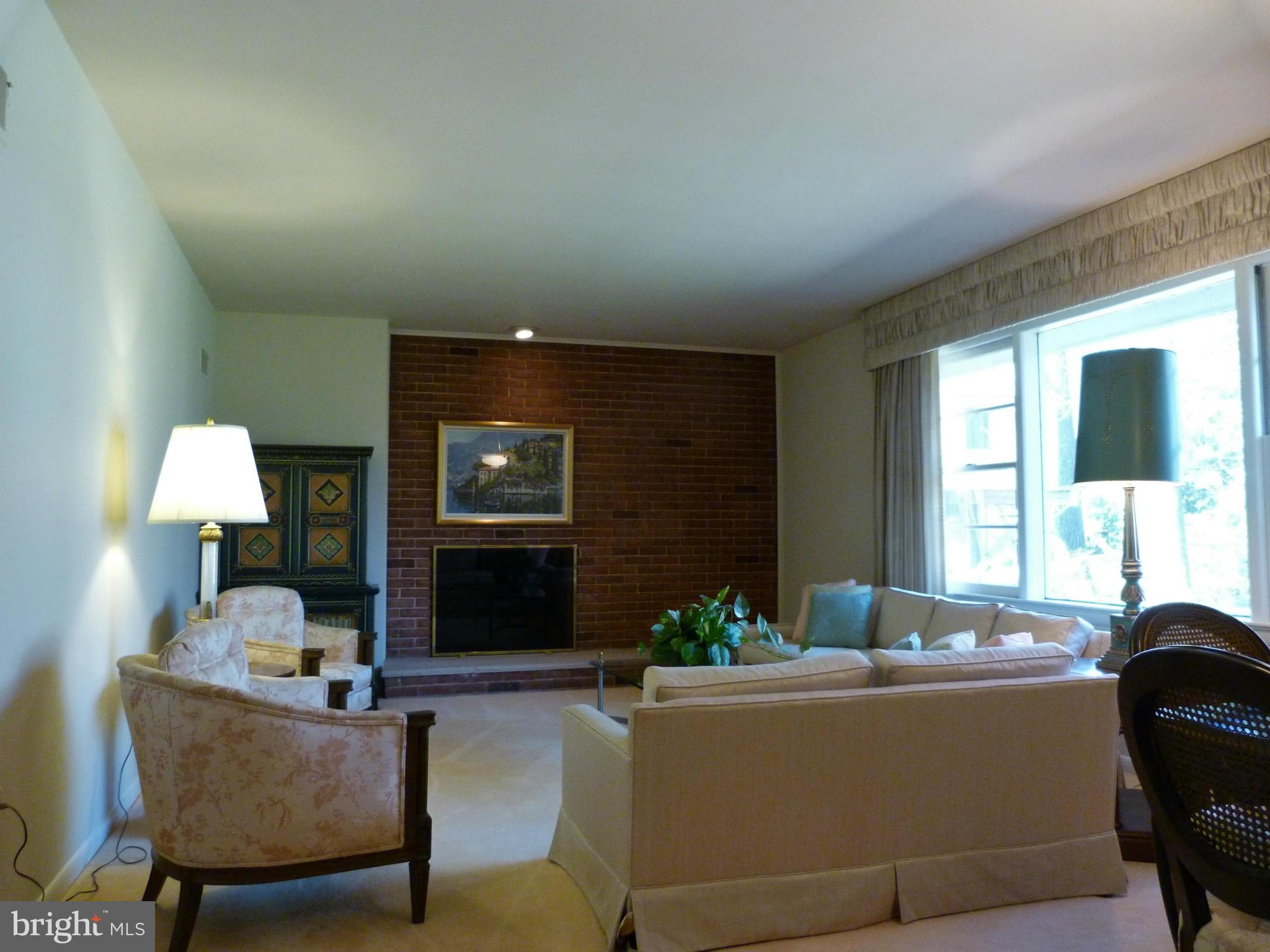 9508 Midwood Road Silver Spring, MD 20910 - Photo 4 of 10 a living room with furniture a window and a fireplace