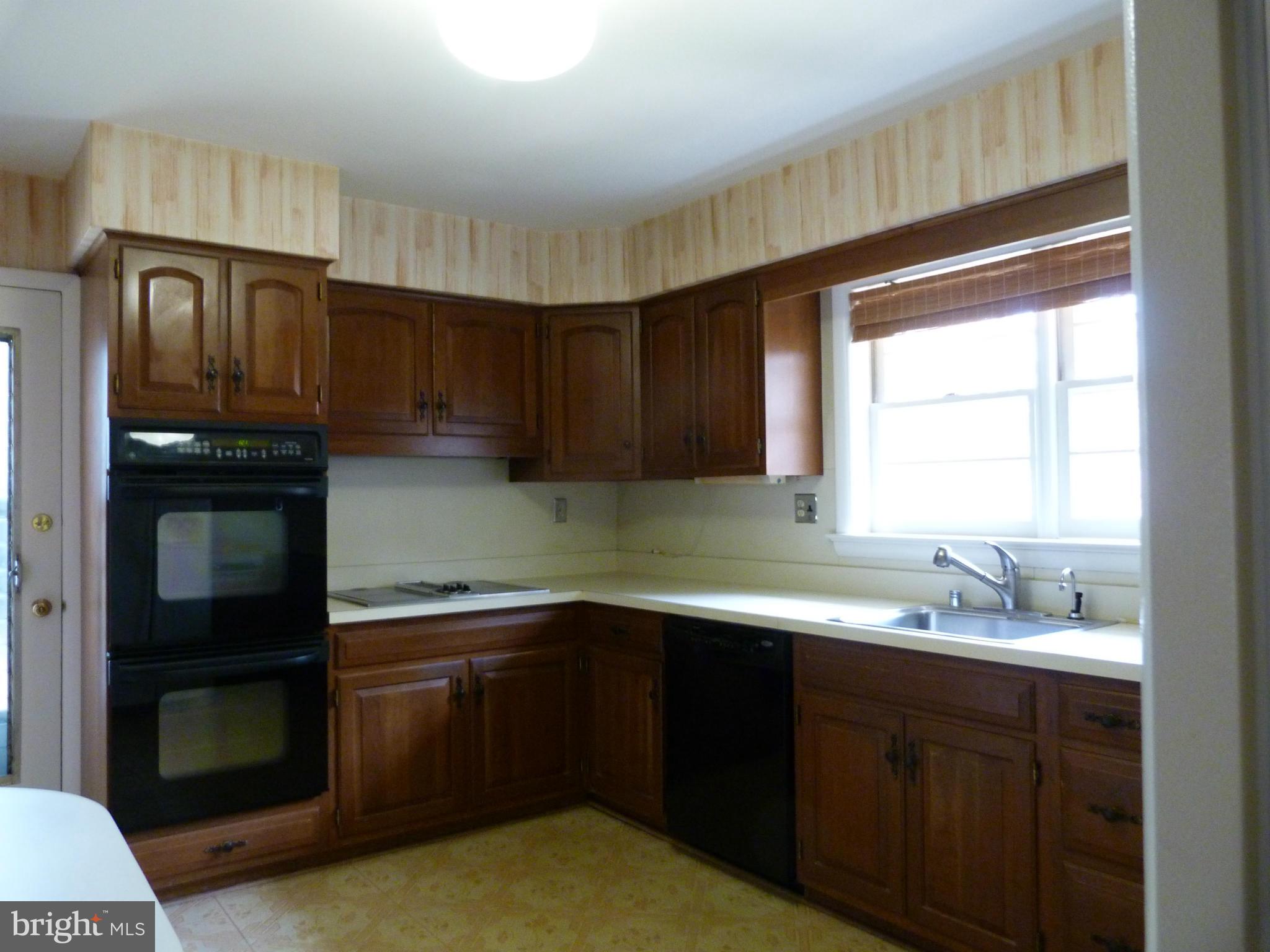 9508 Midwood Road Silver Spring, MD 20910 - Photo 5 of 10 a kitchen with a sink cabinets and window