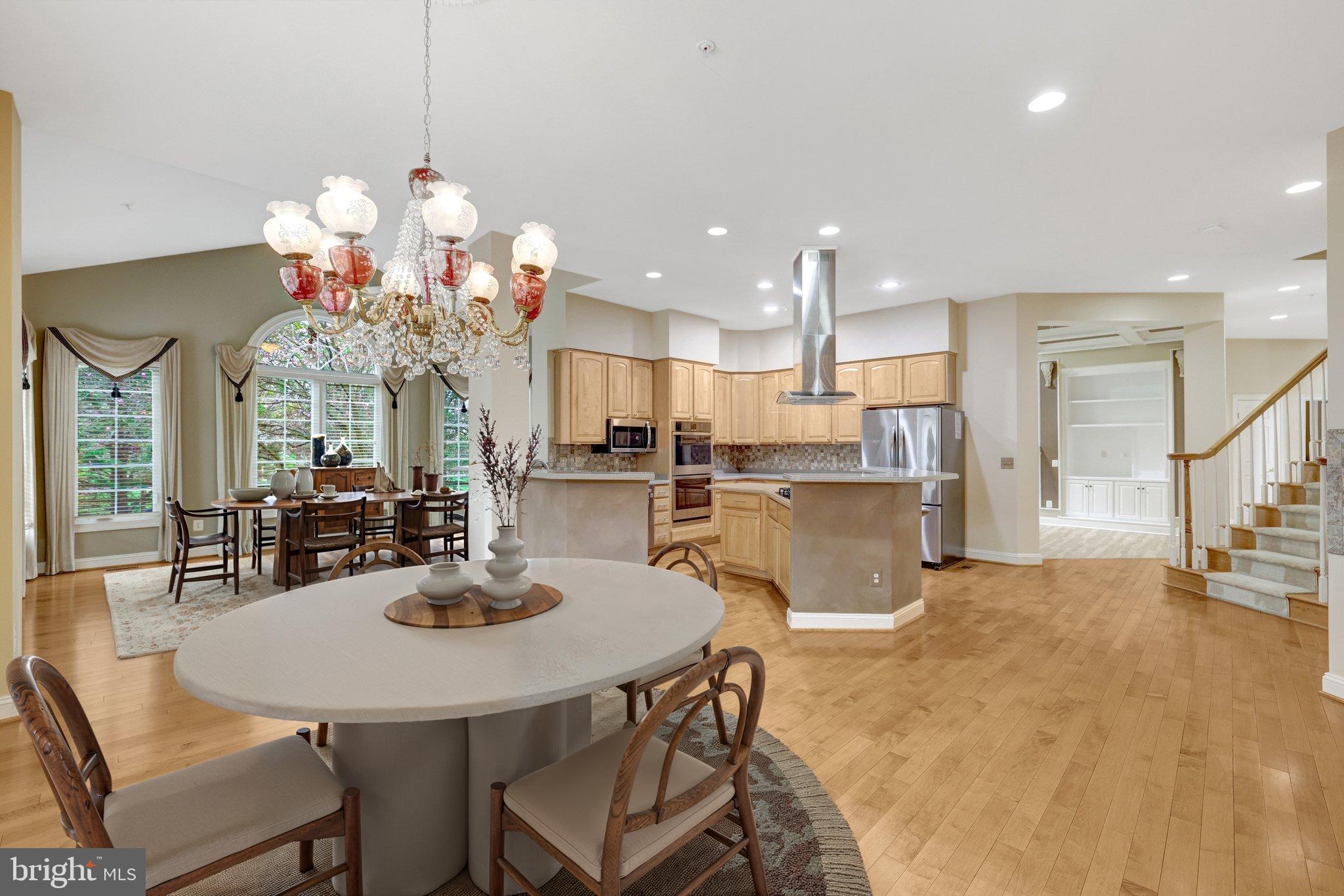 20443 Cliftons Point Street Sterling, VA 20165 - Photo 24 of 37 a view of a dining room and a kitchen with a chandelier