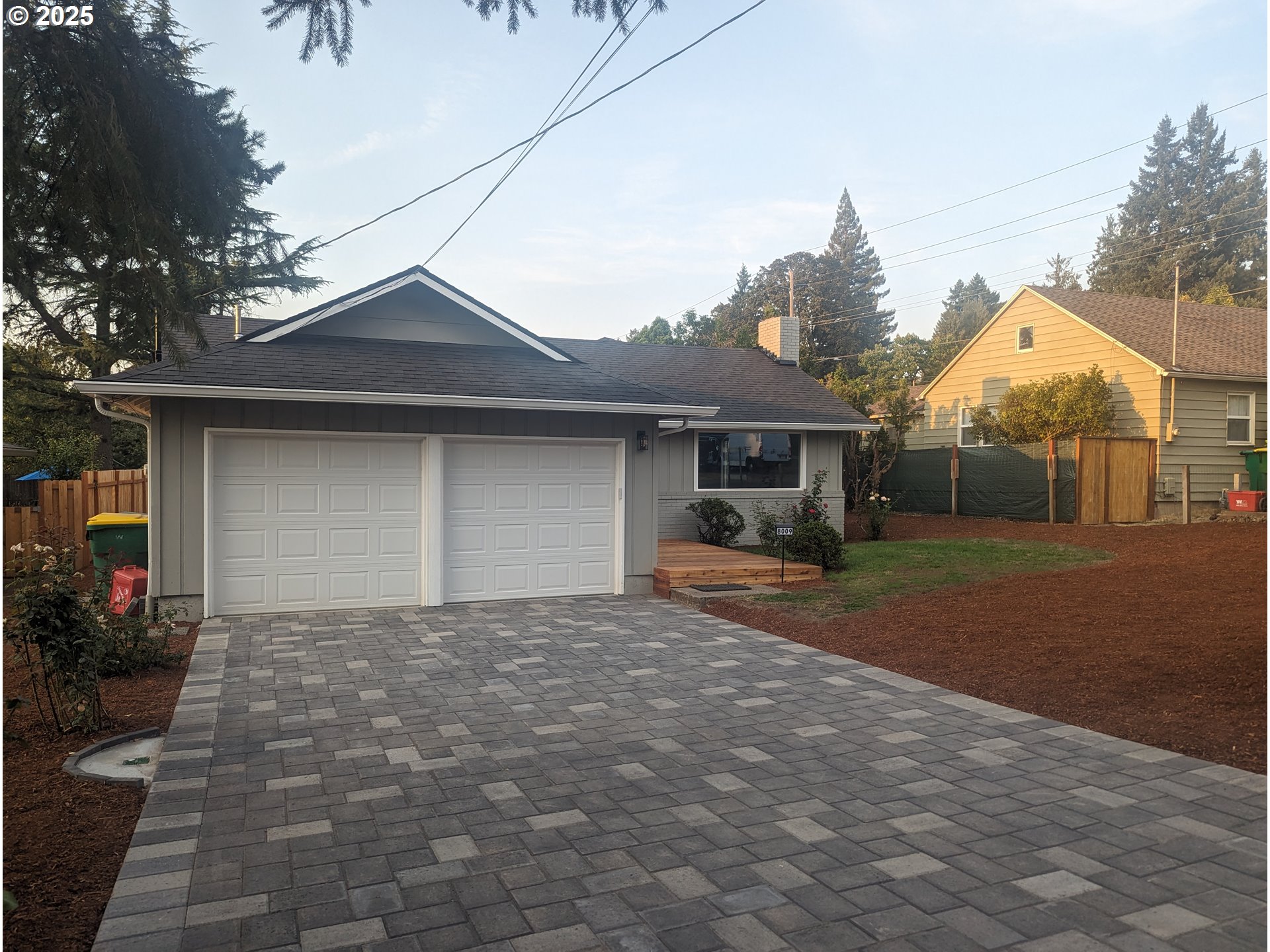 8009 Southwest Mapleleaf Street Portland, OR 97223 - Photo 1 of 16 a front view of a house with a yard and garage