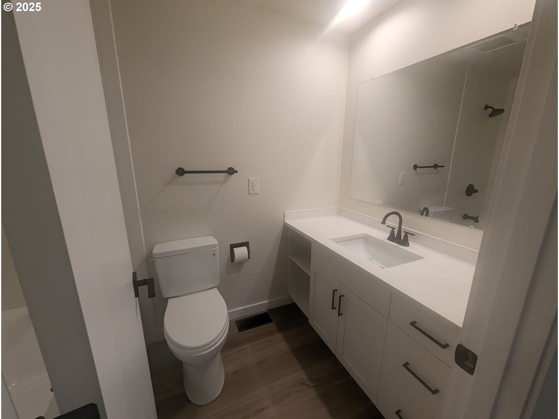 8009 Southwest Mapleleaf Street Portland, OR 97223 - Photo 11 of 16 a bathroom with a toilet sink and mirror