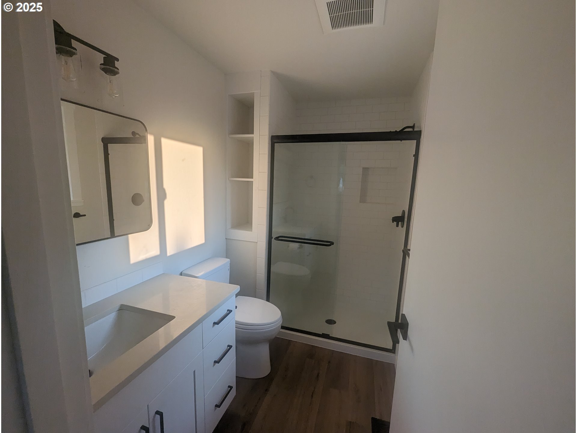 8009 Southwest Mapleleaf Street Portland, OR 97223 - Photo 15 of 16 a bathroom with a granite countertop sink toilet and shower
