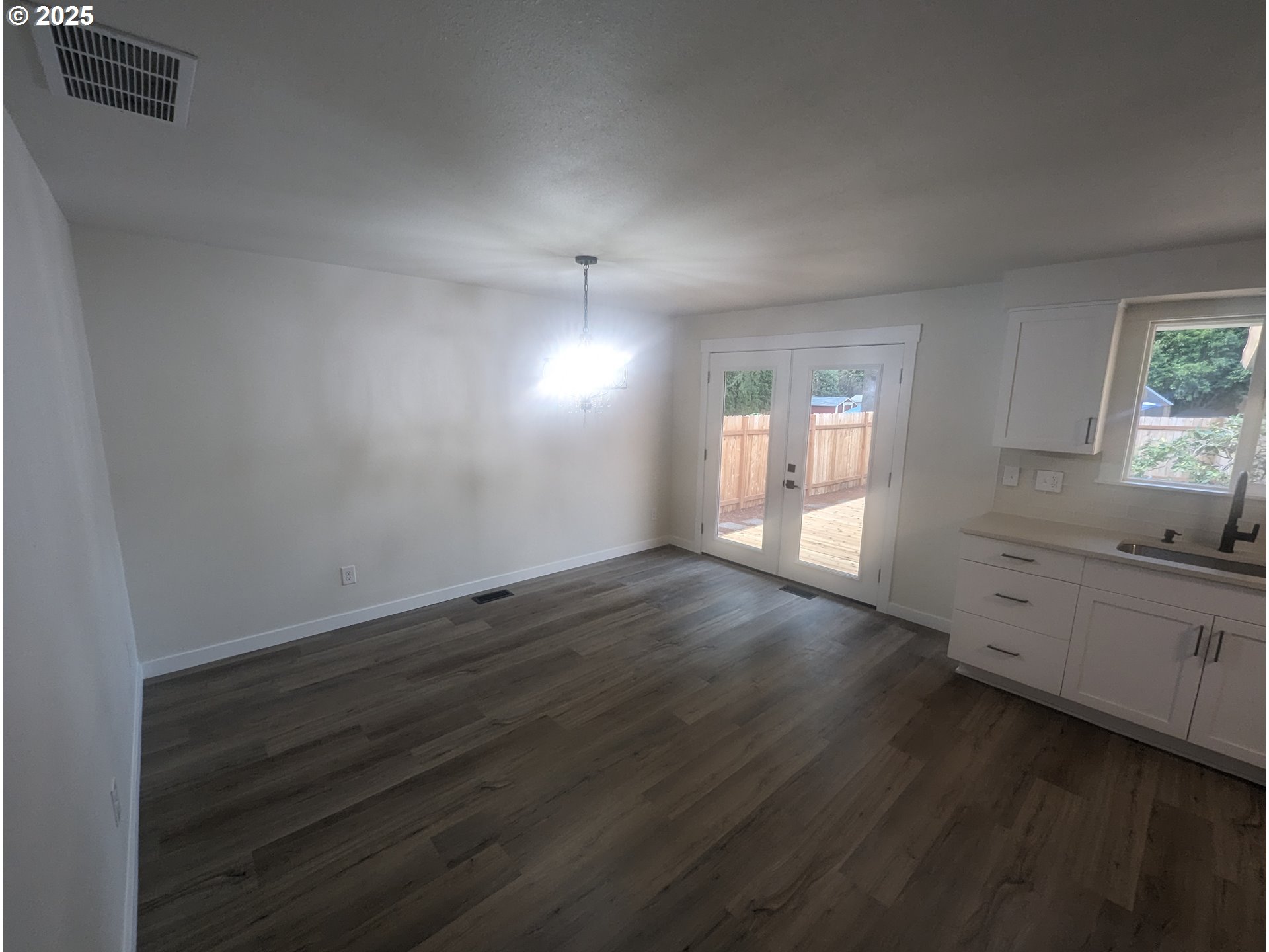 8009 Southwest Mapleleaf Street Portland, OR 97223 - Photo 6 of 16 an empty room with wooden floor and windows