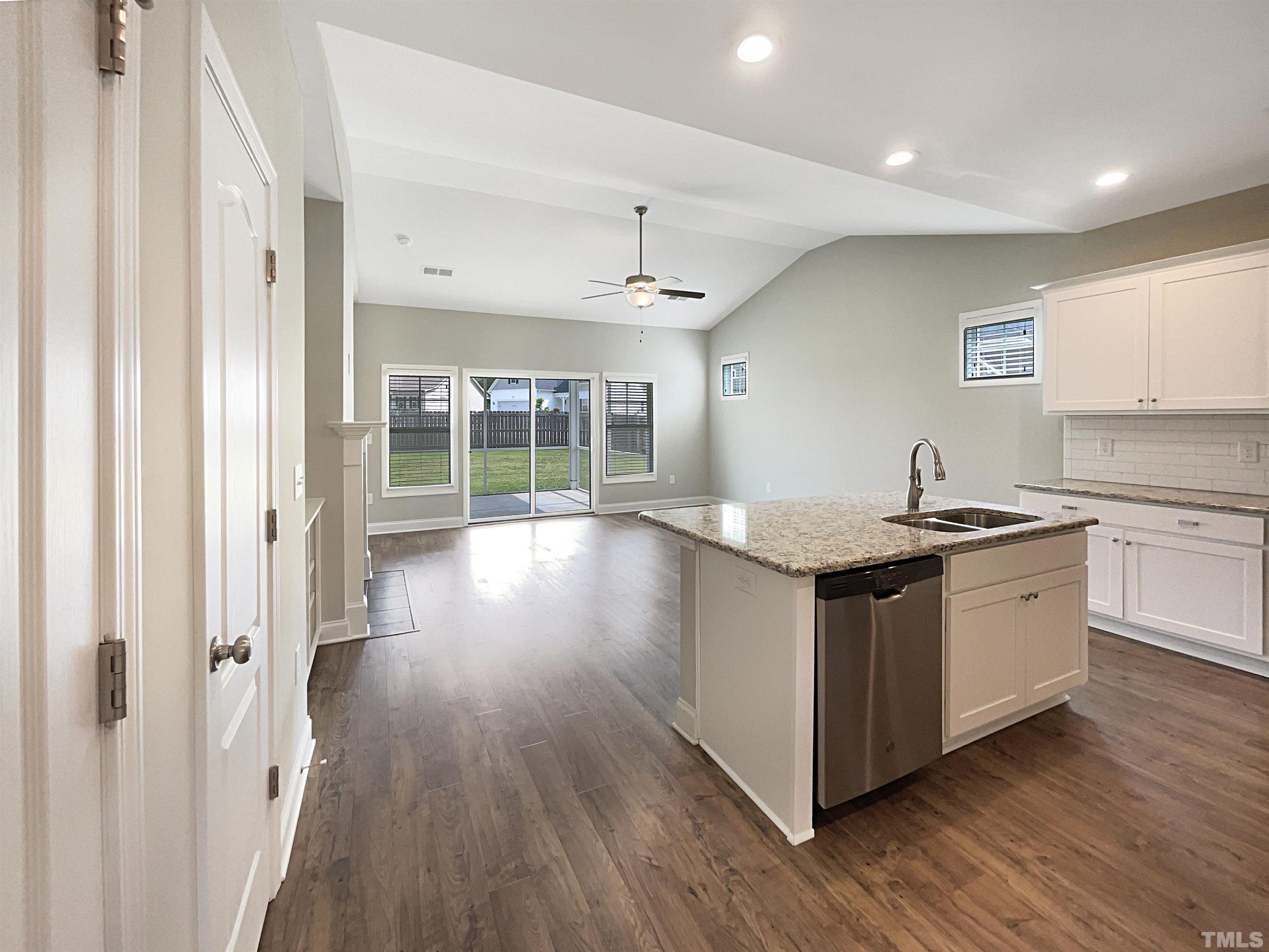 295 Edgefield Street Clayton, NC 27520 - Photo 14 of 21 a kitchen with granite countertop a sink and a stove top oven