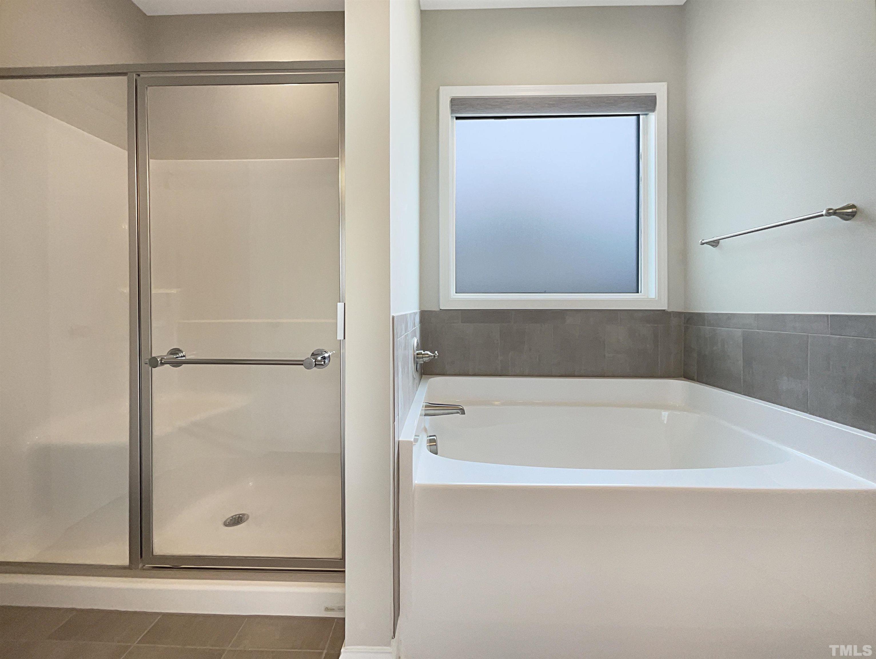 295 Edgefield Street Clayton, NC 27520 - Photo 18 of 21 a bathroom with a bathtub