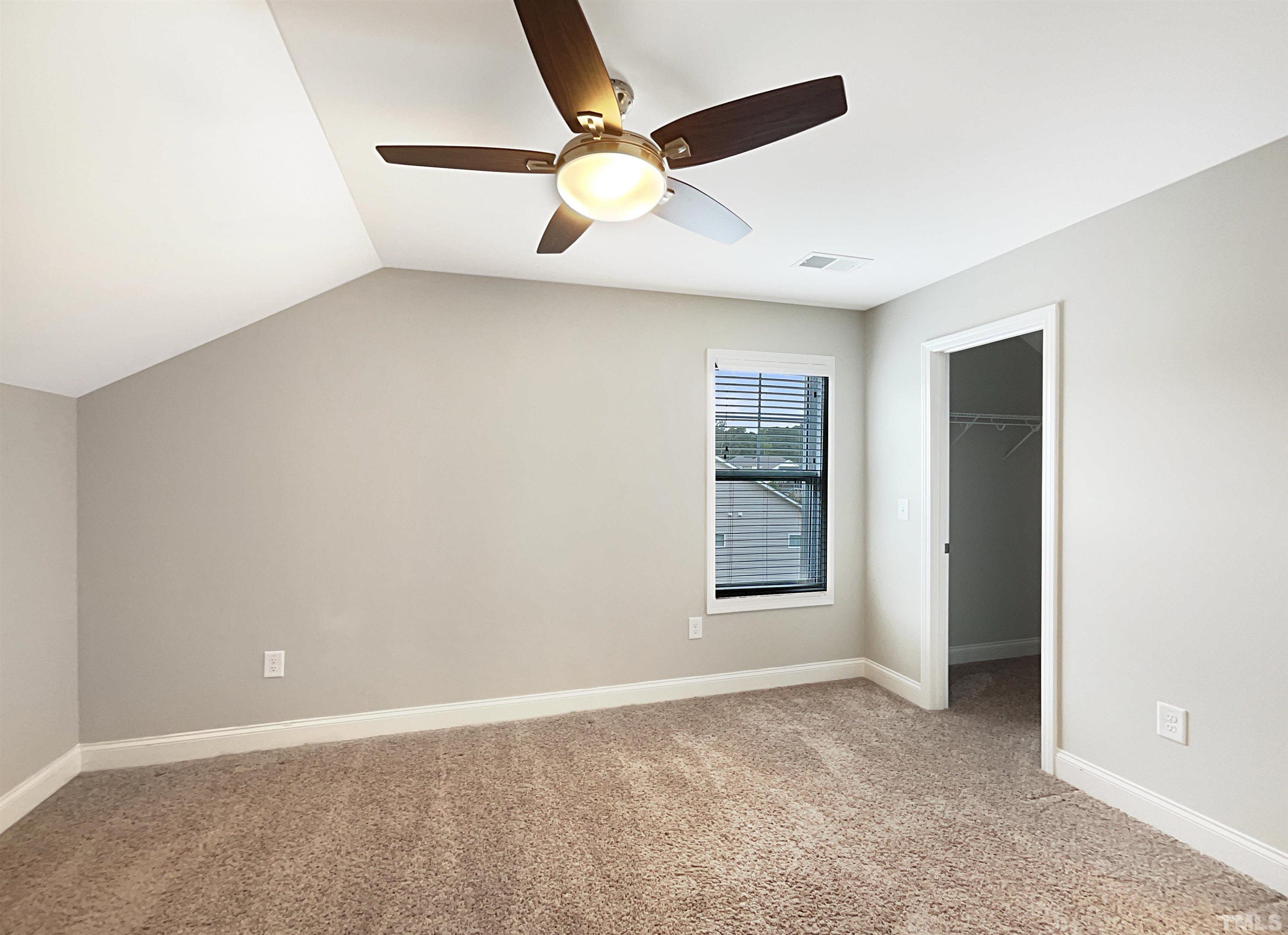 295 Edgefield Street Clayton, NC 27520 - Photo 21 of 21 an empty room with ceiling fan and window