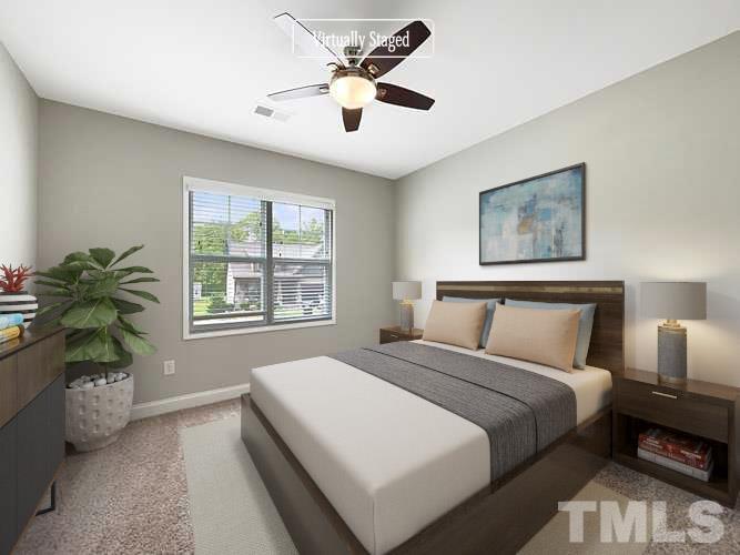 295 Edgefield Street Clayton, NC 27520 - Photo 3 of 21 a bedroom with a bed and a potted plant