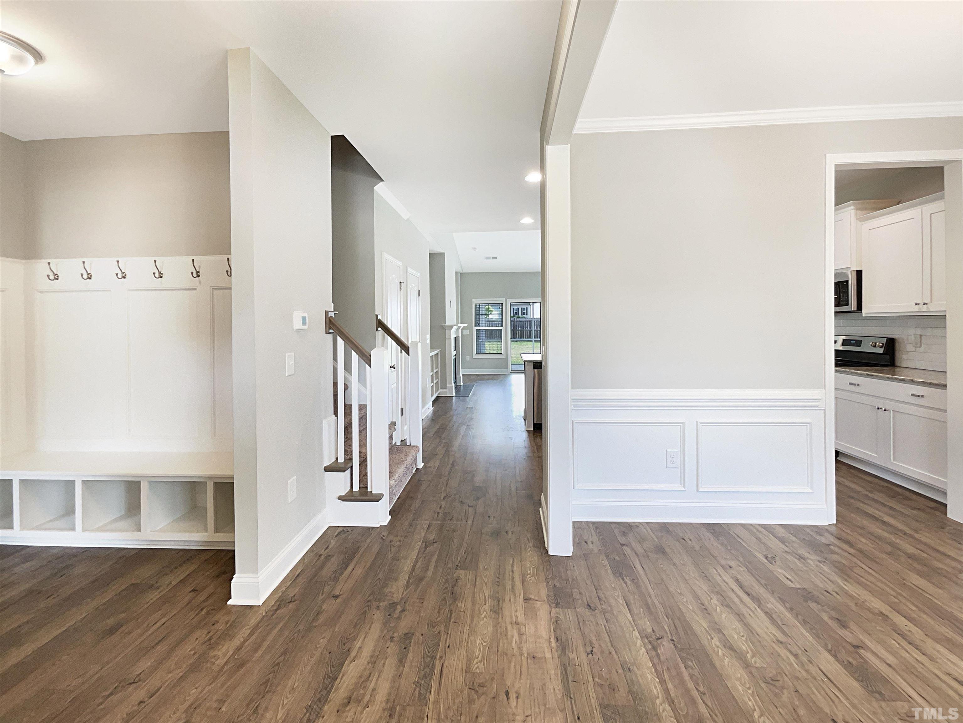 295 Edgefield Street Clayton, NC 27520 - Photo 8 of 21 a view of a hallway view with wooden floor and staircase