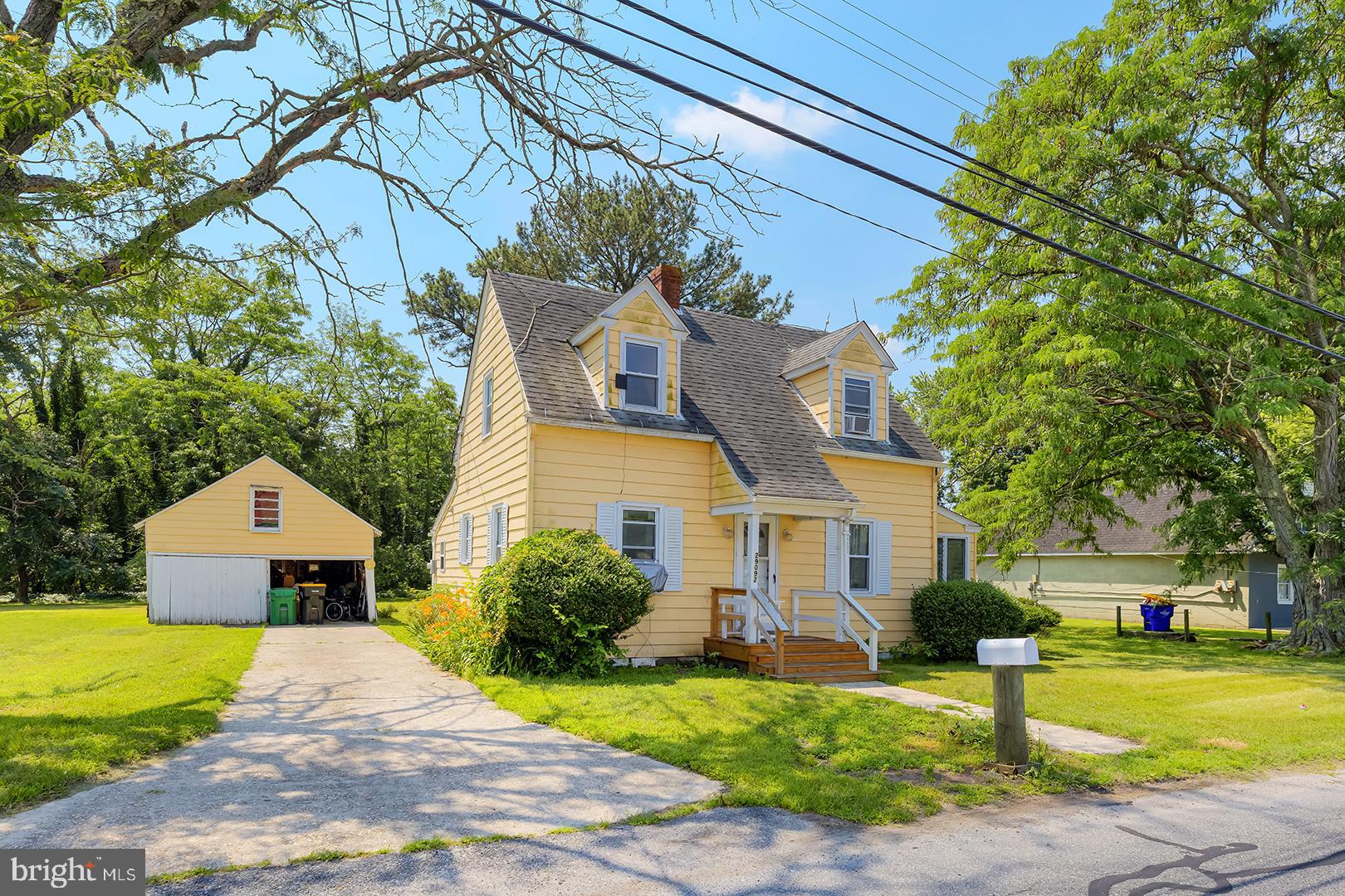 29092 Piney Neck Road Dagsboro, DE 19939 - Photo 2 of 49 a front view of a house with a yard and garage