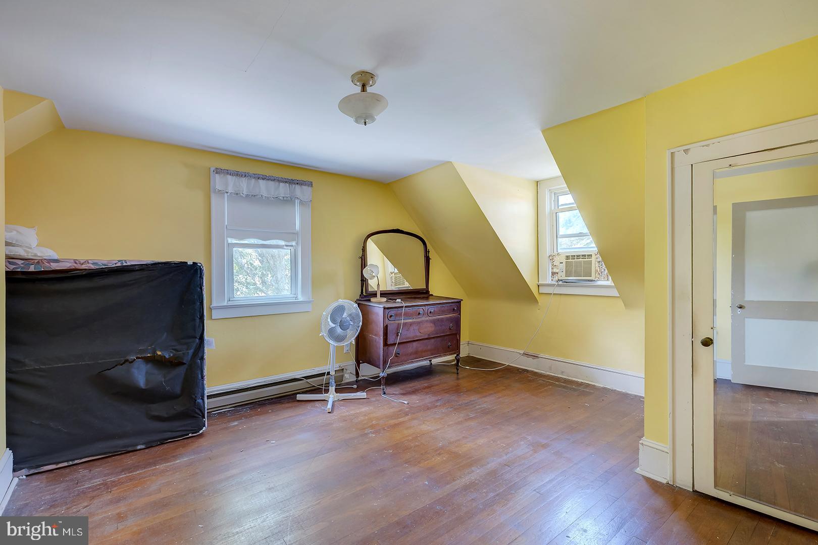 29092 Piney Neck Road Dagsboro, DE 19939 - Photo 26 of 49 a bedroom with a bed and wooden floor