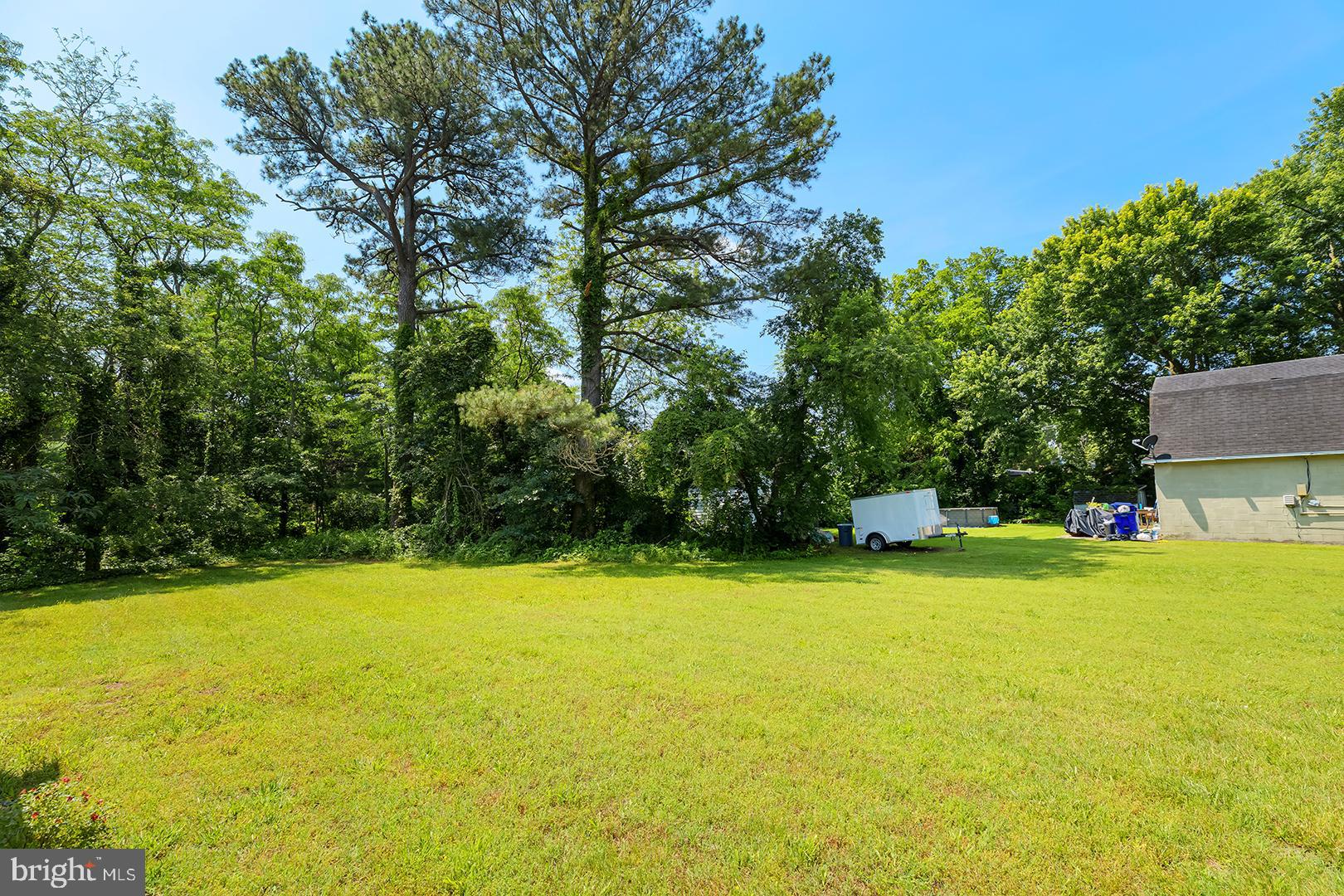 29092 Piney Neck Road Dagsboro, DE 19939 - Photo 36 of 49 a view of a swimming pool and trees in the background