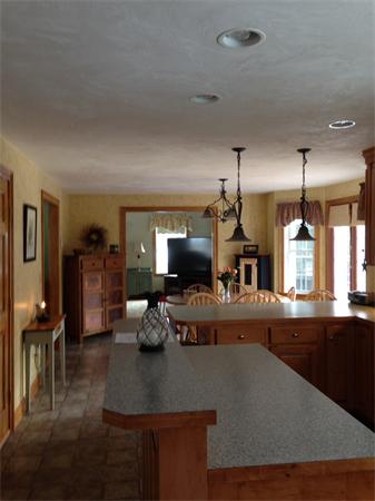 10 Adams Road Townsend, MA 01469 - Photo 29 of 30 a kitchen with a table chairs and flat screen tv