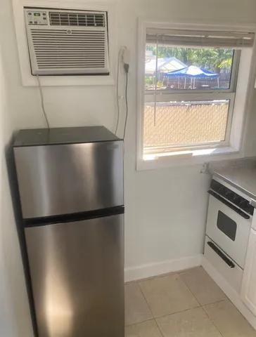 a kitchen with a refrigerator and a window