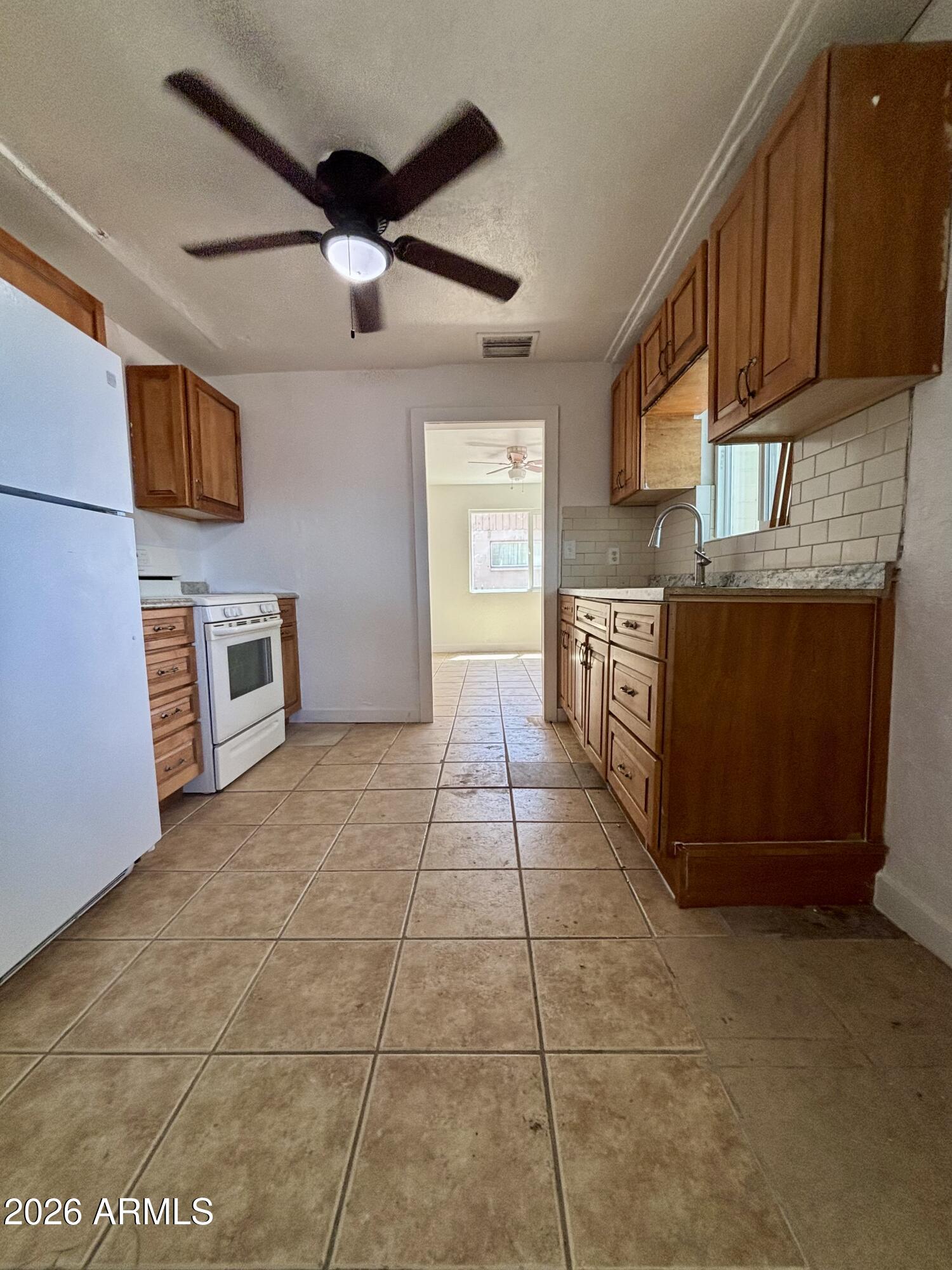 3036 West Almeria Road Phoenix, AZ 85009 - Photo 6 of 20 a kitchen with granite countertop a stove top oven a sink dishwasher and a microwave oven on the blue kitchen countertops