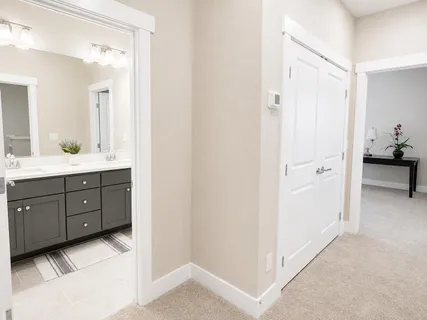 a en suite bathroom with a granite countertop sink and a mirror