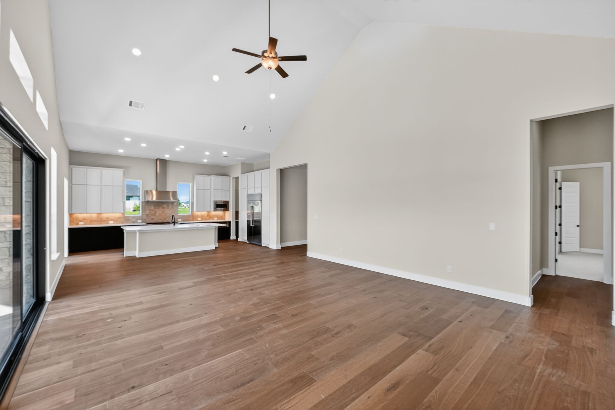 205 Three Rivers Road Georgetown, TX 78633 - Photo 6 of 32 a view of kitchen with kitchen island a sink wooden floor and a refrigerator