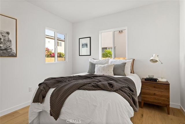 a bed sitting in a bedroom next to a window
