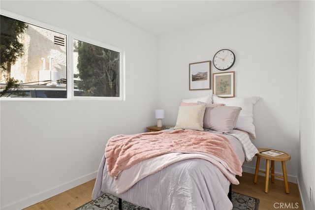 a bedroom with a bed and a painting on the wall