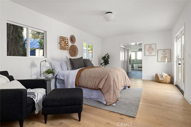 a spacious bedroom with a bed and couch