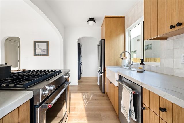 a kitchen with stainless steel appliances granite countertop a stove and a sink
