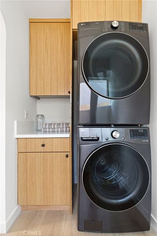 a utility room with sink dryer and washer