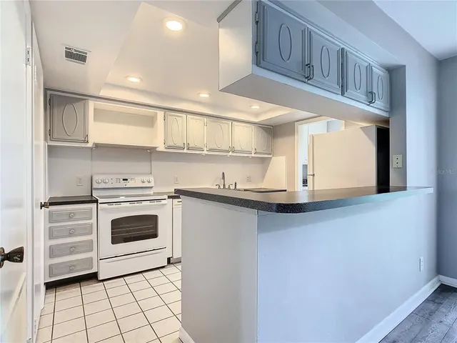 a kitchen with stainless steel appliances granite countertop a sink and cabinets