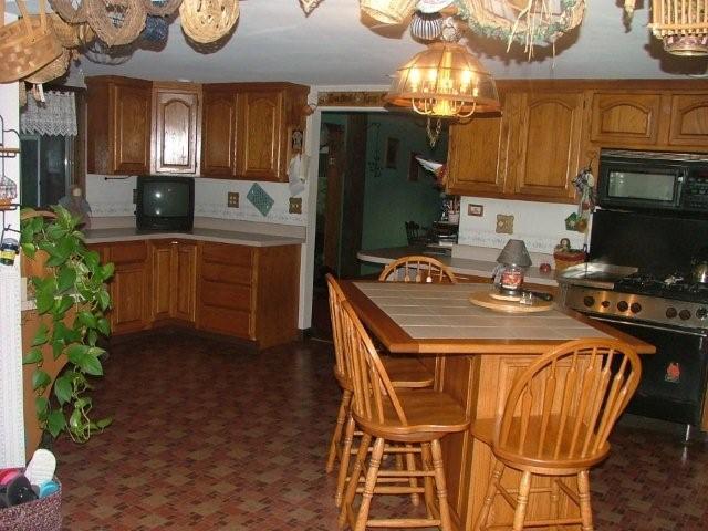 528 North Washington State Road Washington, MA 01223 - Photo 3 of 12 a kitchen with a table chairs refrigerator and microwave