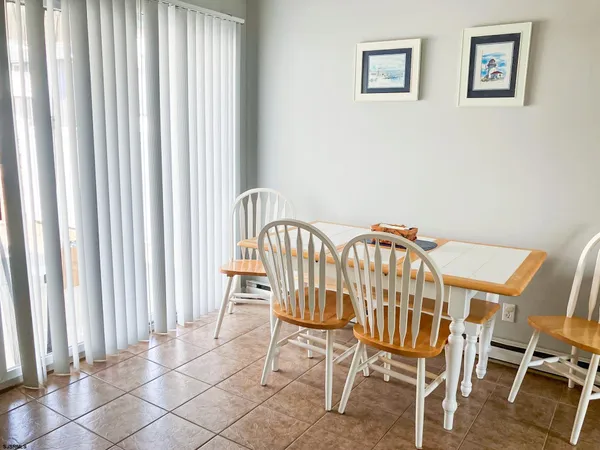 a view of a dining room with furniture and a window
