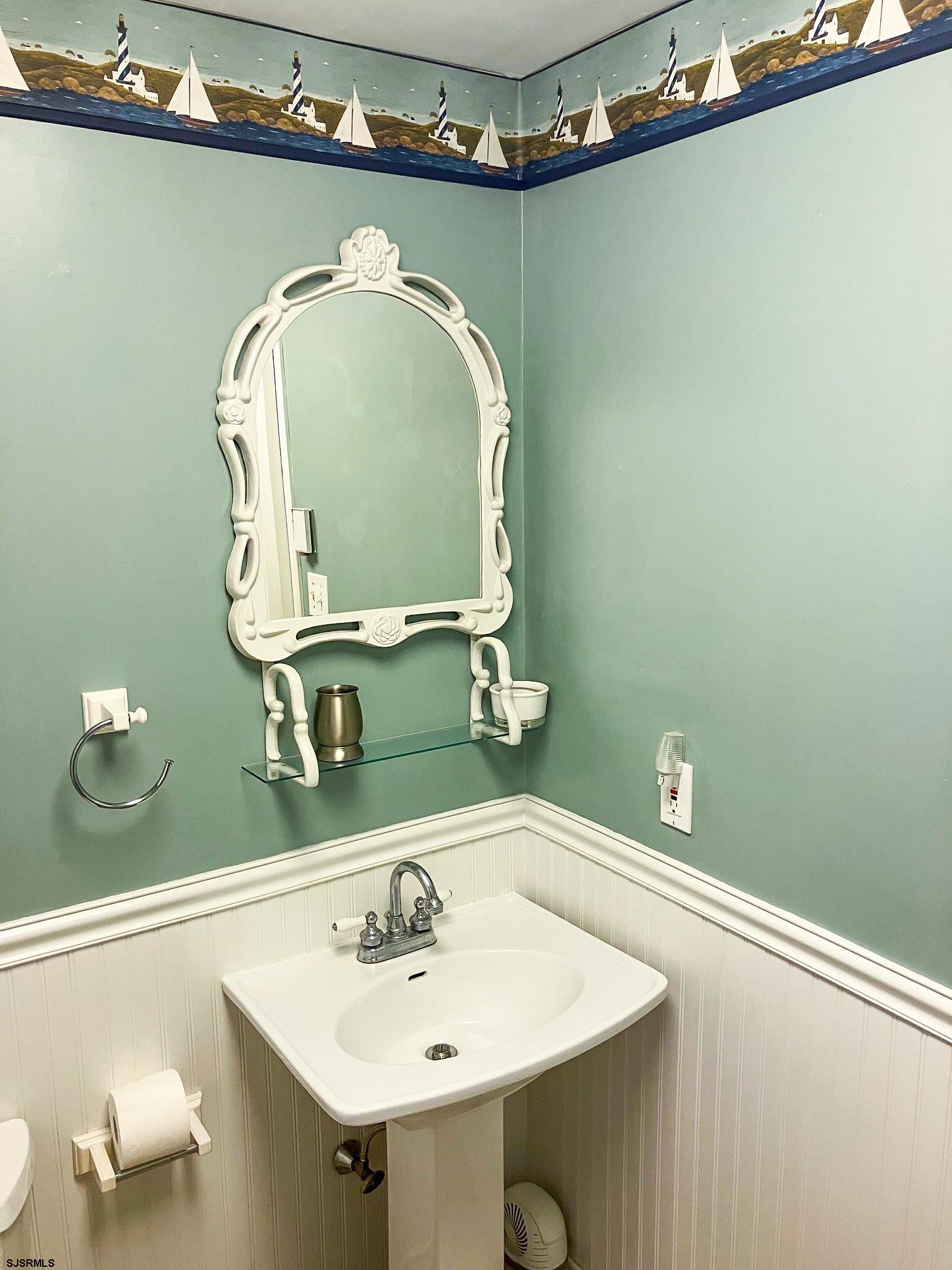 335 42nd Street South, Unit FIRST Brigantine, NJ 08203 - Photo 22 of 23 a bathroom with a sink and mirror