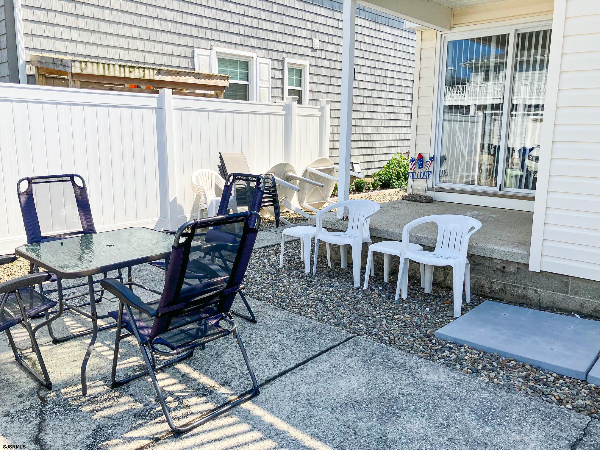 335 42nd Street South, Unit FIRST Brigantine, NJ 08203 - Photo 23 of 23 a view of a dinning table and chairs in backyard of the house