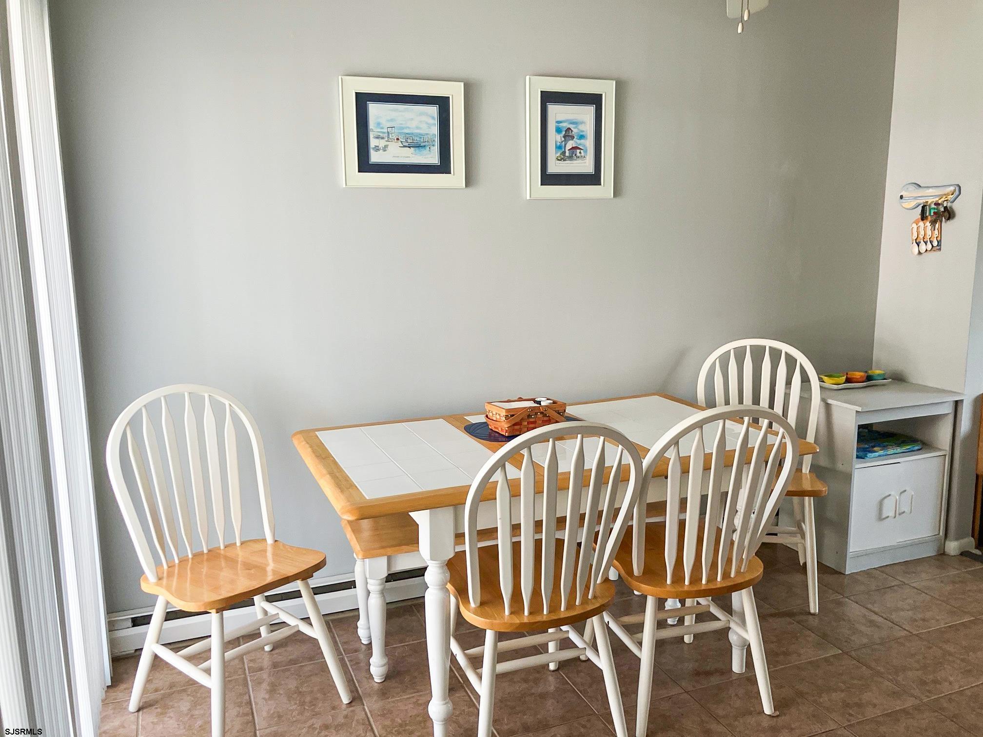 335 42nd Street South, Unit FIRST Brigantine, NJ 08203 - Photo 10 of 23 a view of a dining room with furniture and wooden floor