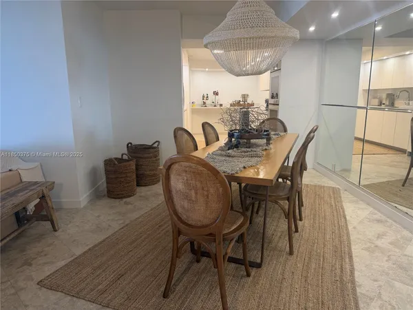a view of a dining room with furniture and a chandelier