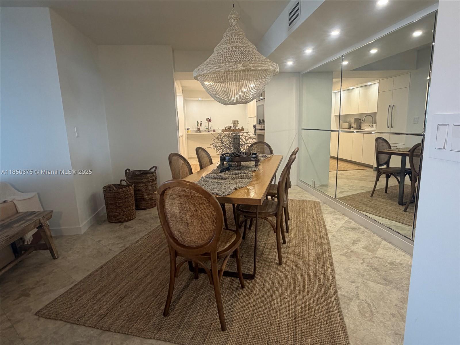 1111 Crandon Boulevard, Unit A404 Key Biscayne, FL 33149 - Photo 16 of 61 a view of a dining room with furniture and a chandelier