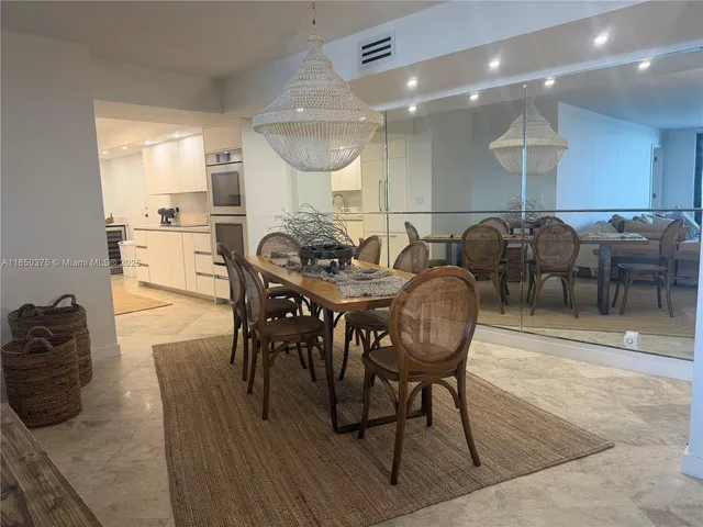 a large white kitchen with a stove top oven a sink and dishwasher
